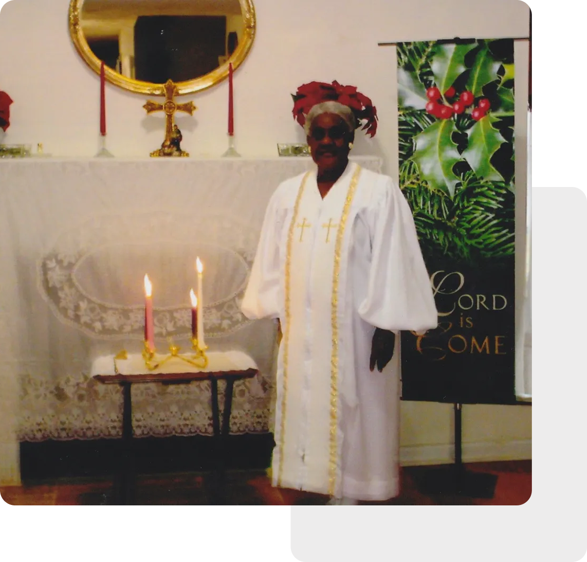 A person in a ceremonial robe stands by an altar adorned with lit candles and a festive banner, reminiscent of the serene ambiance found in Christian churches.